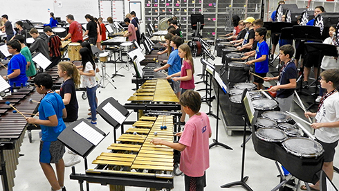 Students begin to put together the mass ensemble the day before the concert