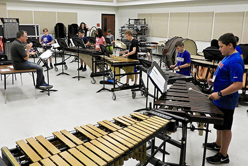 Kennan Wylie rehearses one of the blue ensembles